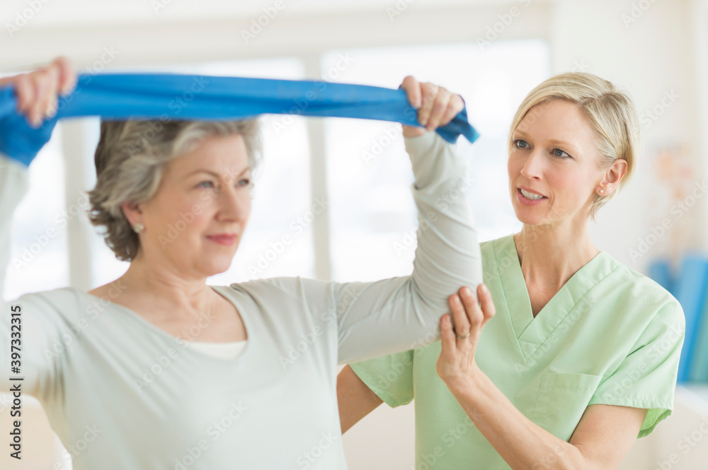 Mature woman exercising with personal trainer Mature woman exercising with personal trainer