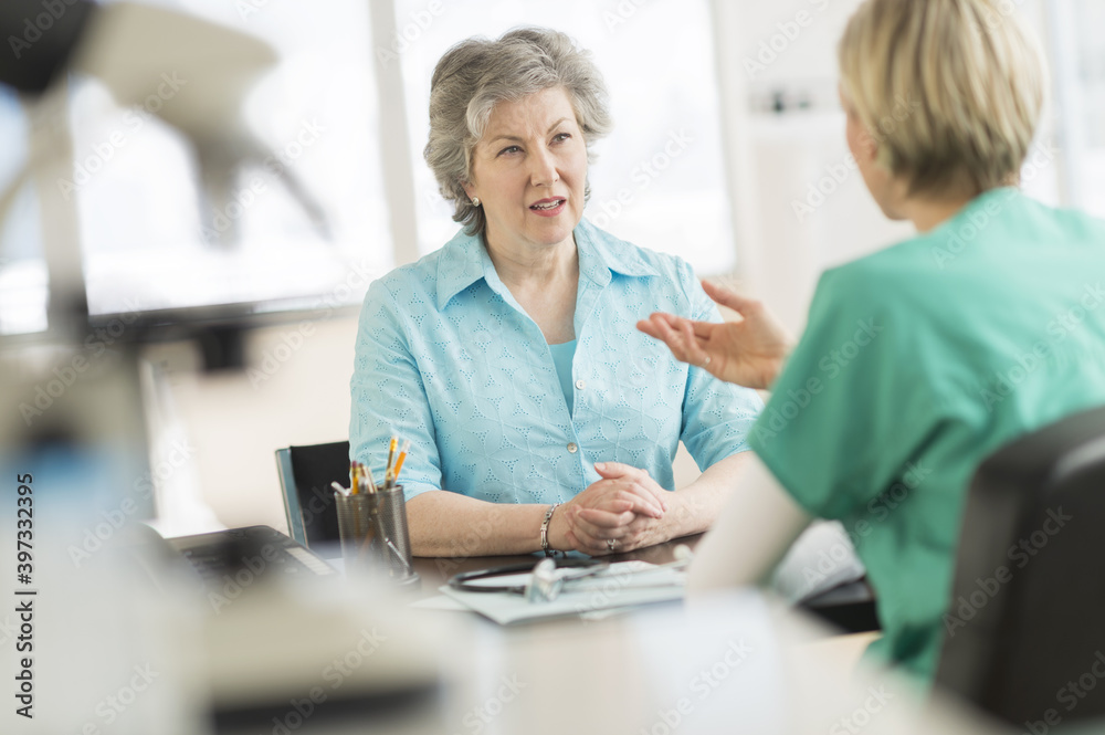 Doctor talking to patient in doctor's office Doctor talking to patient in doctor's office