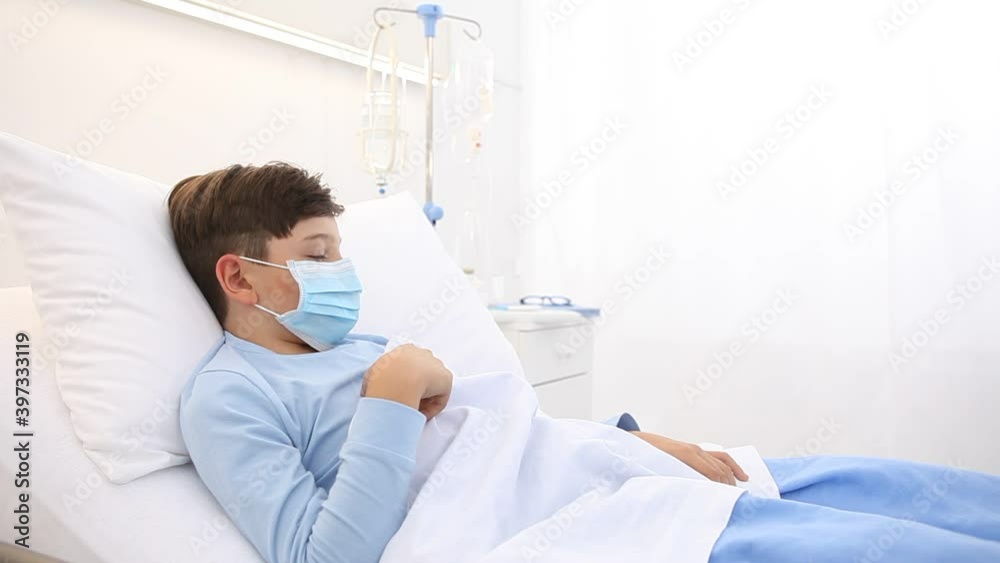 coronavirus covid 19 protection concept, child in the hospital bed, nurse with thermometer measures temperature of the fever, wearing protective masks coronavirus covid 19 protection concept, child in the hospital bed, nurse with thermometer measures temperature of the fever, wearing protective masks
