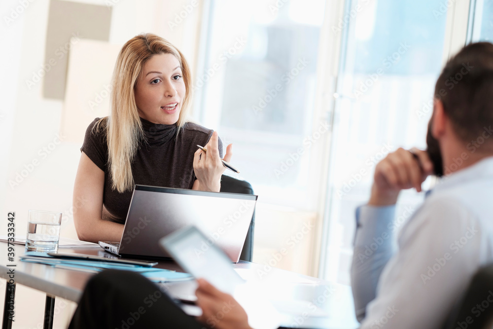 Man and woman talking in office Man and woman talking in office