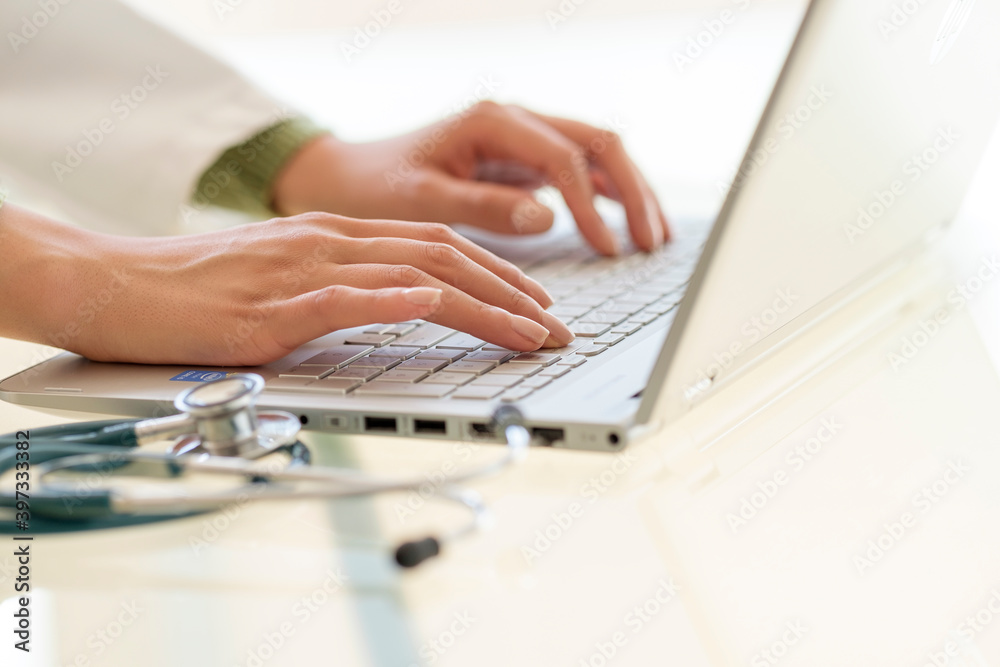 Hands typing on laptop keyboard Hands typing on laptop keyboard