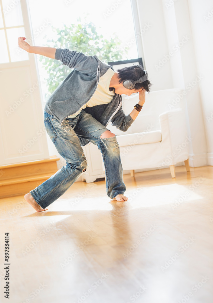 Teenage boy (16-17) dancing in living room Teenage boy (16-17) dancing in living room