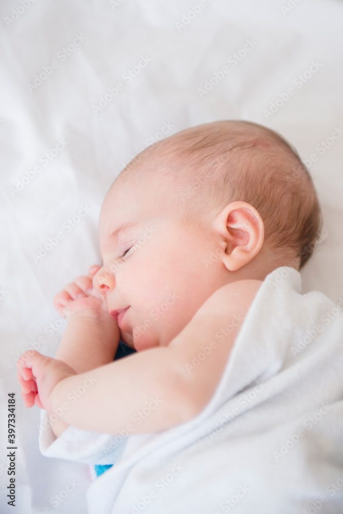 Baby girl (2-5 months) sleeping on bed Baby girl (2-5 months) sleeping on bed