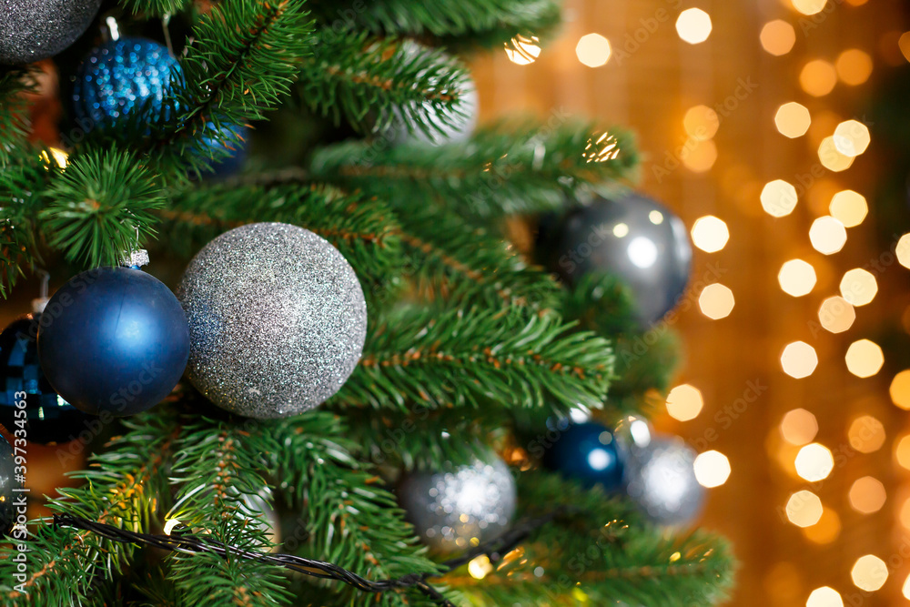 Beautiful Christmas tree decorated with blue and silver toys. New Years is soon. Decorations for Christmas Day Beautiful Christmas tree decorated with blue and silver toys. New Years is soon. Decorations for Christmas Day