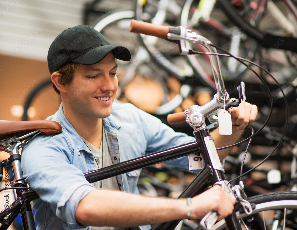 Man fixing bike in bike shop Man fixing bike in bike shop