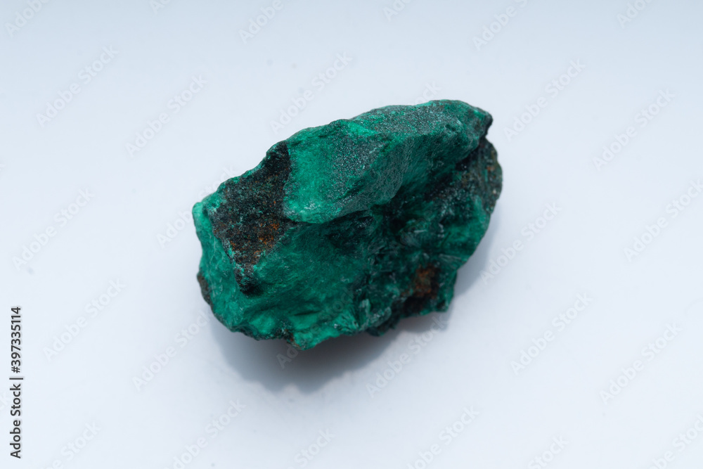 Malachite green ore on a white background. Natural green malachite Malachite green ore on a white background. Natural green malachite