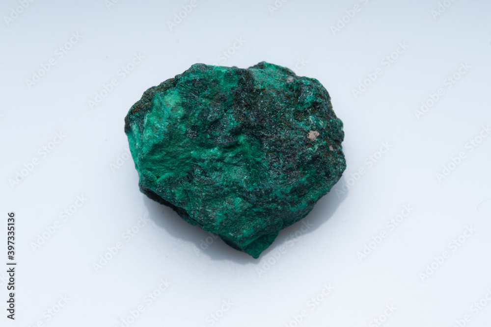 Malachite green ore on a white background. Natural green malachite Malachite green ore on a white background. Natural green malachite