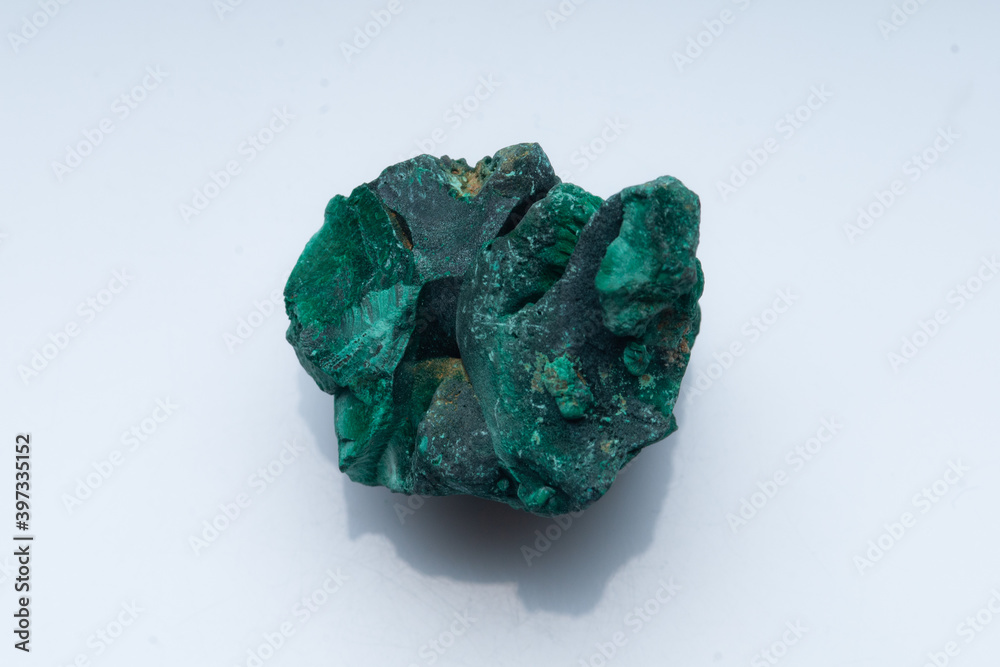 Malachite green ore on a white background. Natural green malachite Malachite green ore on a white background. Natural green malachite
