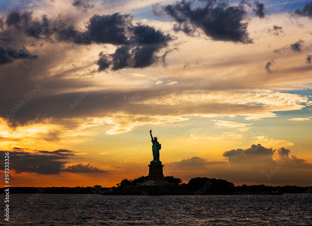 Silhouette of Statue of Liberty at sunset