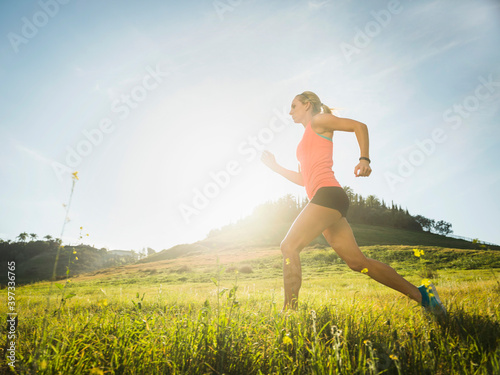 Woman running in field photo