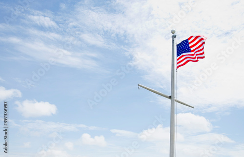 American flag against cloudy sky