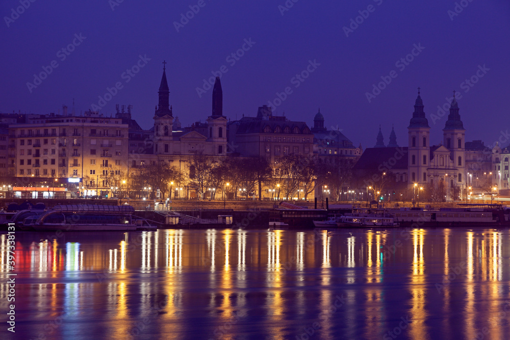 Illuminated waterfront and reflections in river Illuminated waterfront and reflections in river