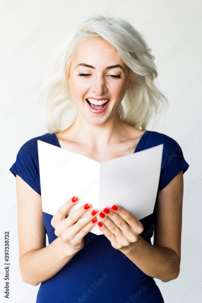 Studio shot of woman holding paper Studio shot of woman holding paper