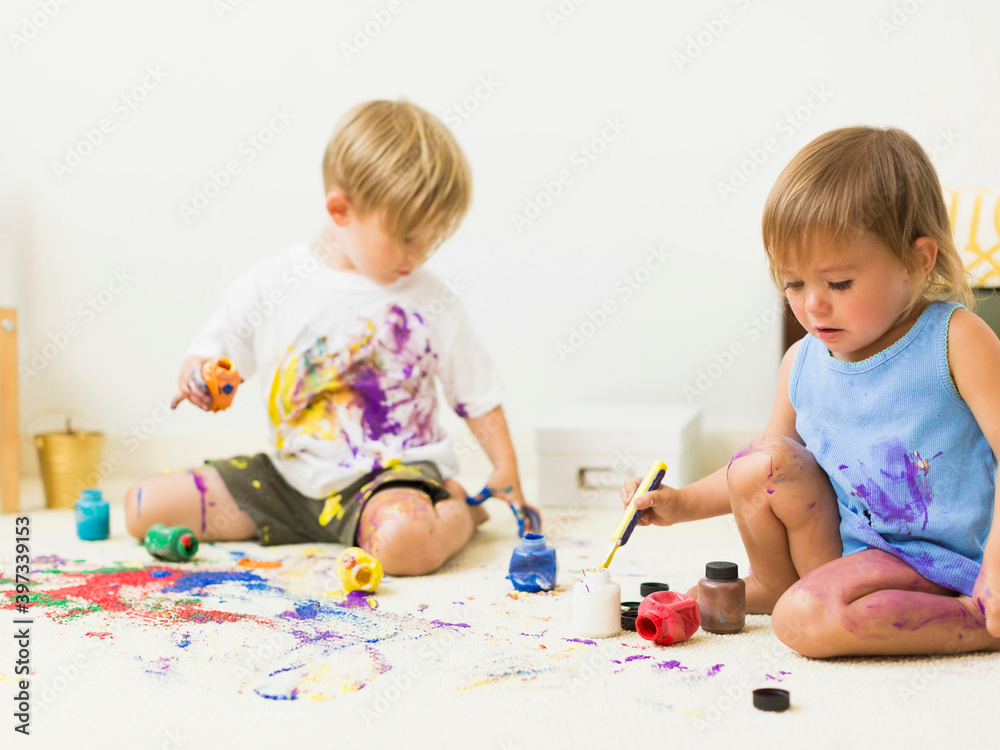 Children (2-3) painting on carpet Children (2-3) painting on carpet