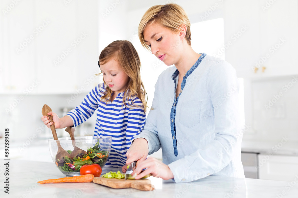 Mother and daughter (4-5) preparing salad Mother and daughter (4-5) preparing salad
