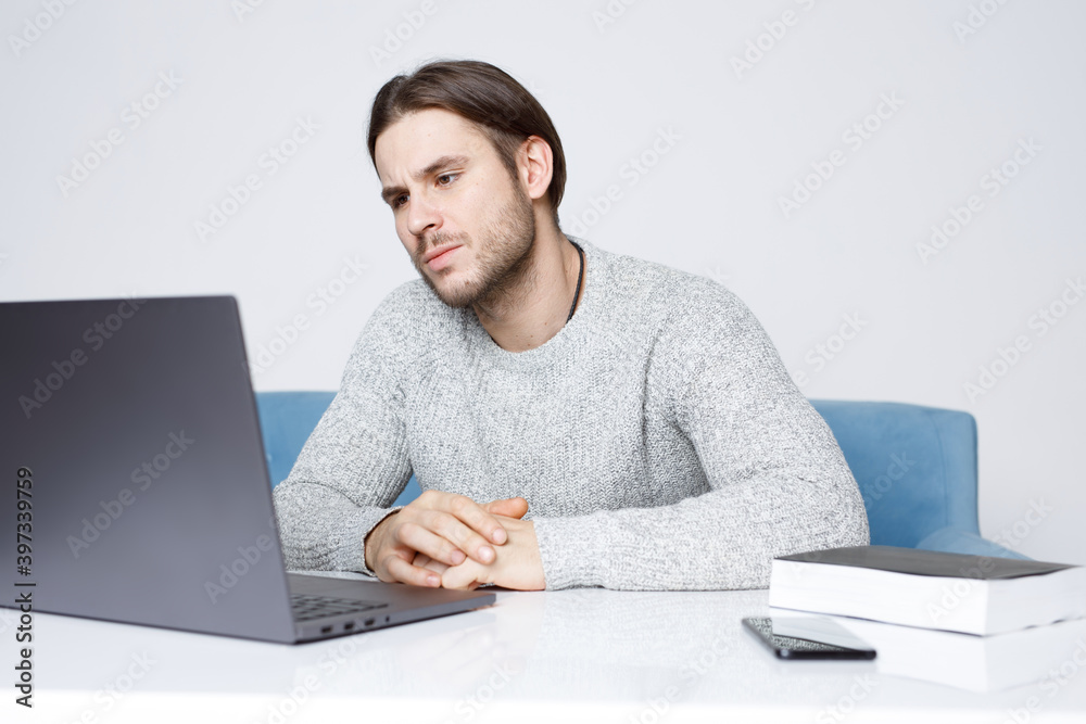 Guy browsing internet on computer and expresses emotions. Young man working on laptop. Guy browsing internet on computer and expresses emotions. Young man working on laptop.