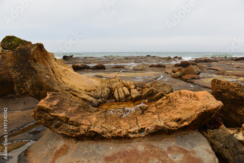 Rock formations on Shag Point beach photo