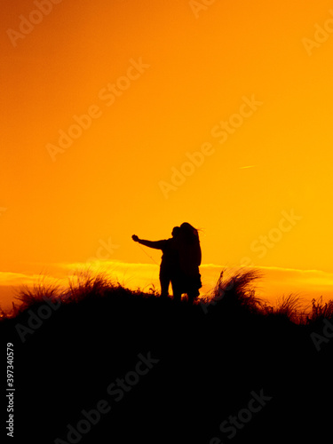 couple hugging in a sunset in the field
