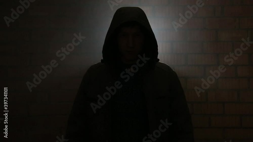 Serial killer in the dark breathing heavily waiting for the victim photo