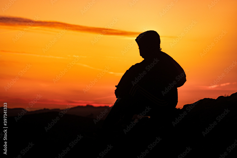 Silhouette of a lonely person at sunset