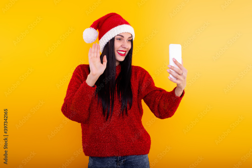 Christmas online congratulations. woman in Santa hat using mobile tablet for video call friends and parents Christmas online congratulations. woman in Santa hat using mobile tablet for video call friends and parents