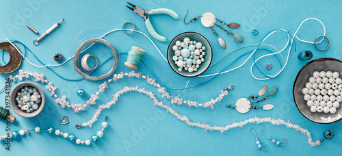 Creative flat lay, panoramic composition. DIY craft hobby. Making handmade jewelry for friends as Christmas gifts. Flat lay on mint color background. photo
