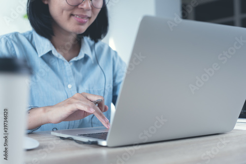 Casual business woman online working on laptop computer at home office