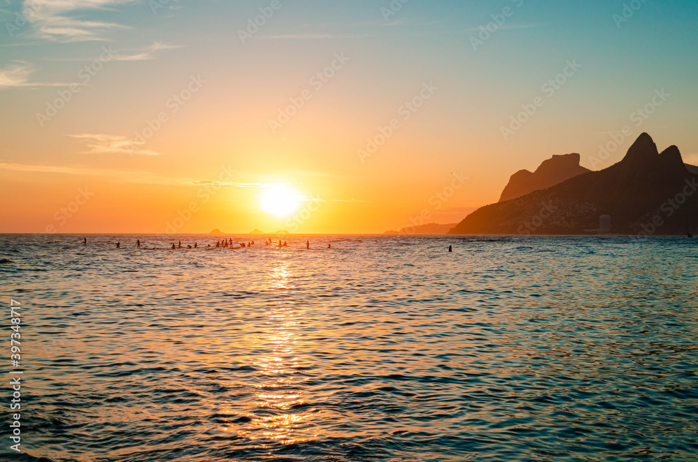 Sunset in rio de janeiro with gavea stone and the two brothers' hill in the background.