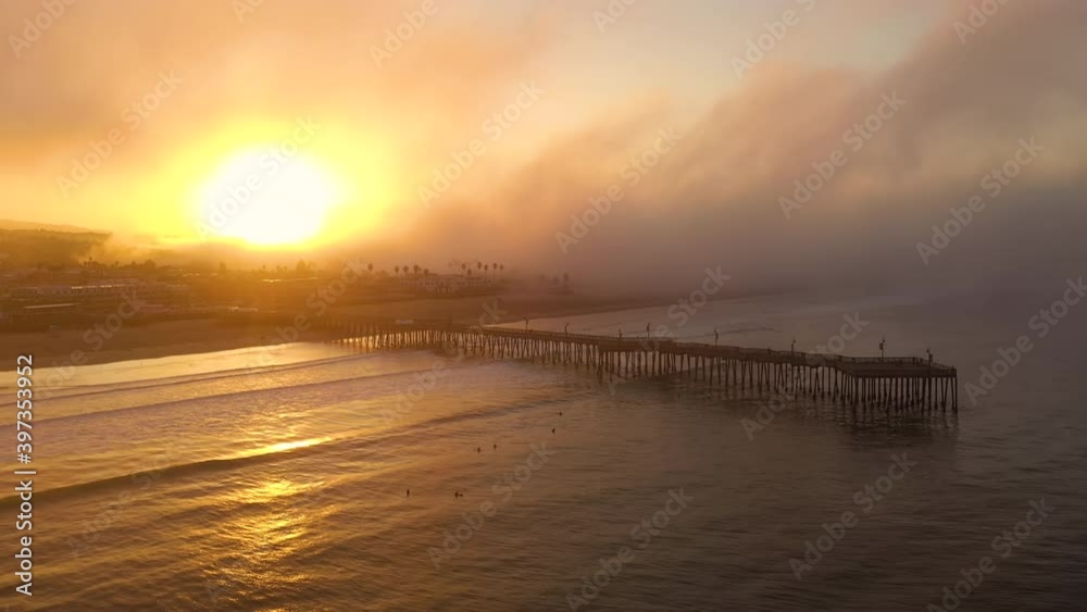 Obscured sunrise at Pismo Beach Pier in California during wildfires. Aerial drone Obscured sunrise at Pismo Beach Pier in California during wildfires. Aerial drone
