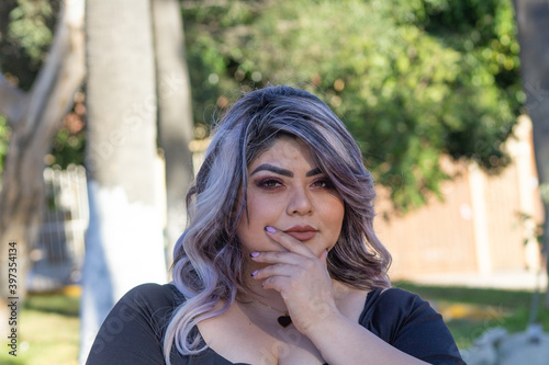 portrait of beautiful chubby model in the park. mexican woman