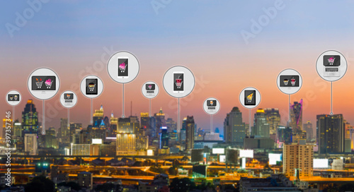 People, Online shopping, Technology concept - Shopping cart with fashion icon on background blur The modern buildings of the city skyscrapers and leave space for adding your content. Panorama..