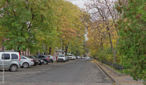 Pushkinskaya Street in autumn day. On the street there are cars