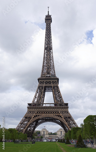 View of the Eiffel Tower from the Champ de Mars. Nearby walk tourists © aleks