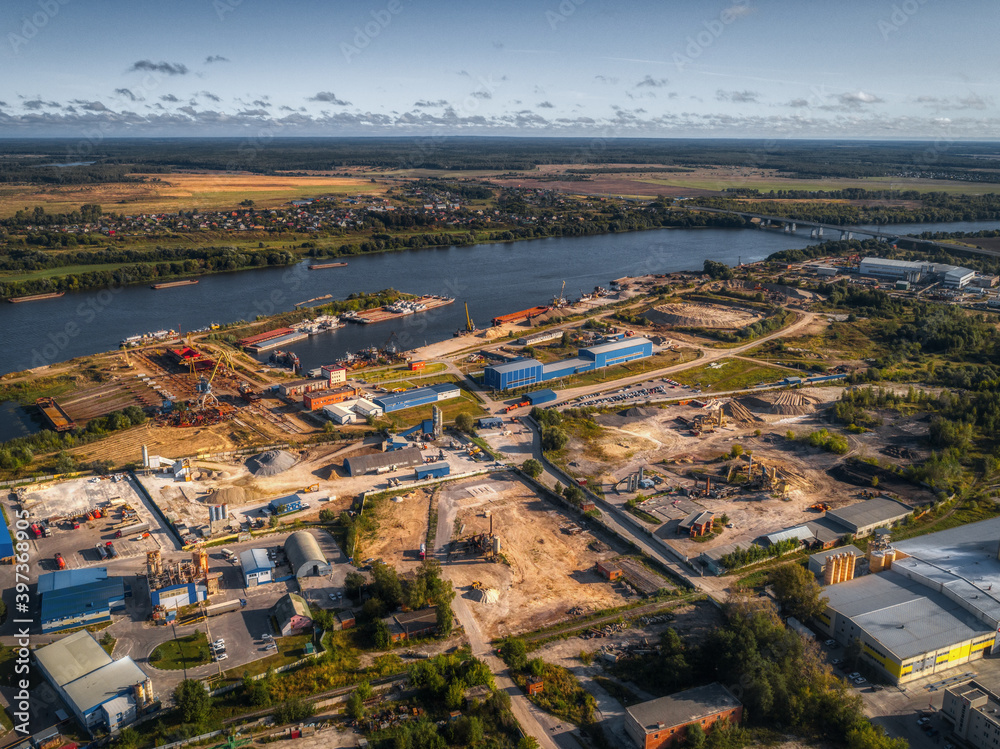 industrial plant on the bank of a large river, aerial view.
