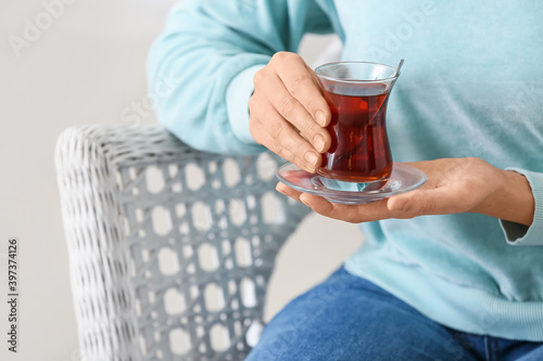 Young woman drinking Turkish tea at home