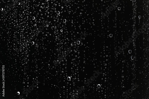 black wet background / raindrops for overlaying on window, concept of autumn weather, background of drops of water rain on glass transparent © kichigin19