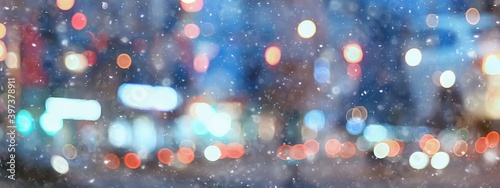 abstract snow blurred background city lights, winter holiday new year photo