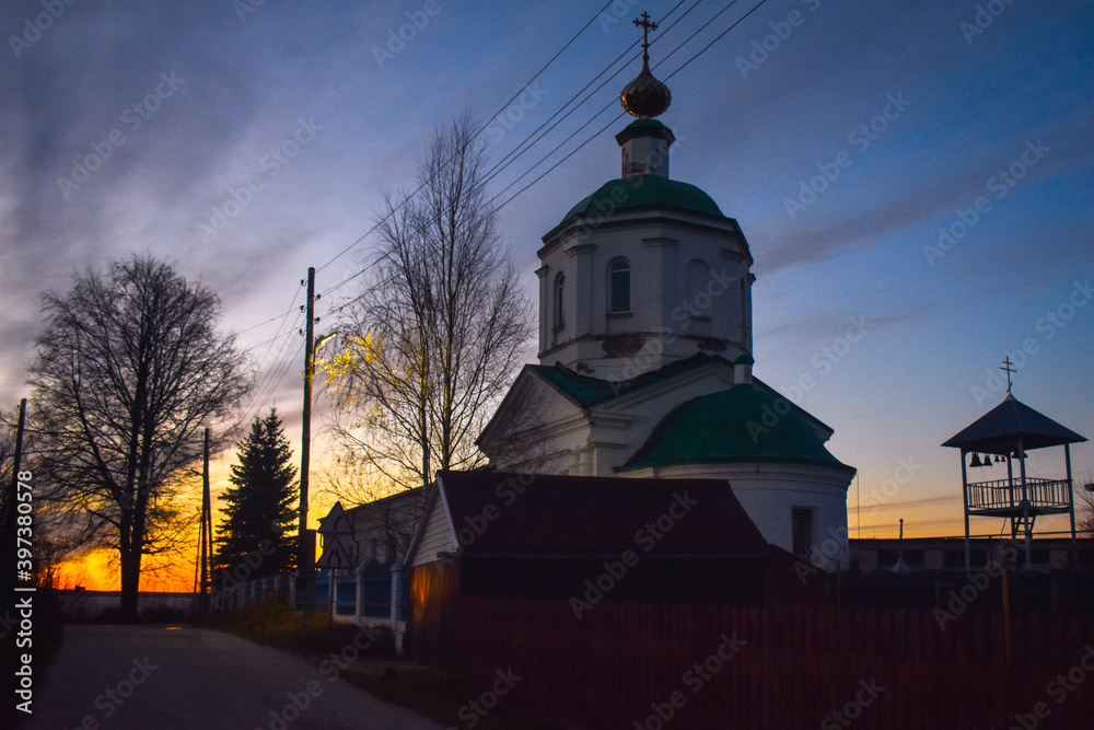 Beautiful village church at sunset