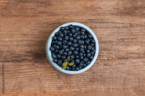 Tasty blueberries on wooden board background, top view. Healthy eating