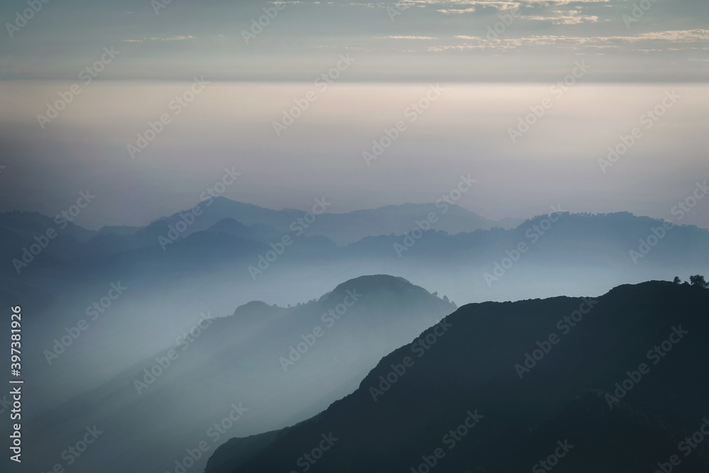 Layers of mountain peaks covered in fog
