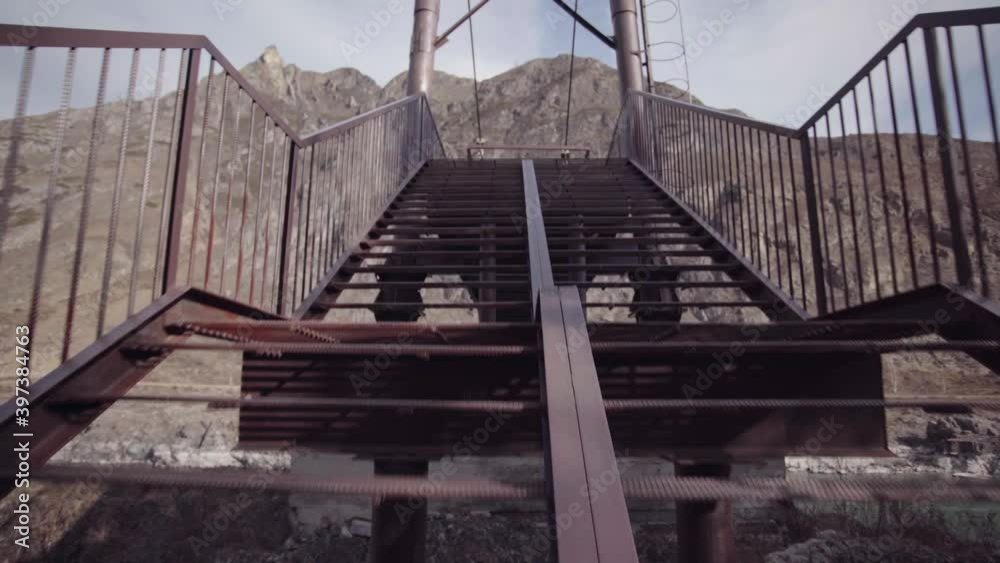 Walking through metallic bridge outdoors. Walking through metallic bridge outdoors.