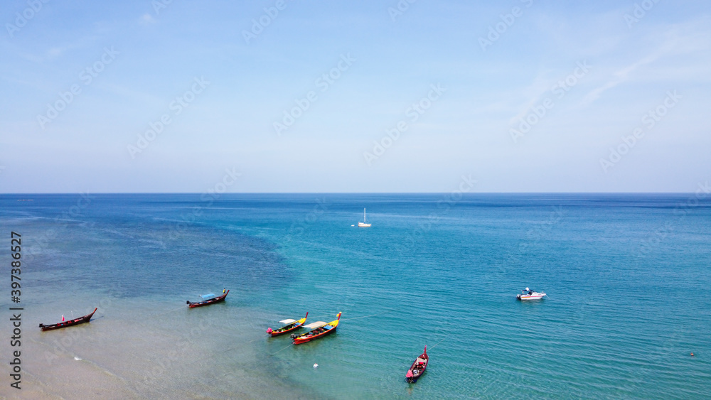 Top view of beautiful sand beach with traditional boat at Phuket.