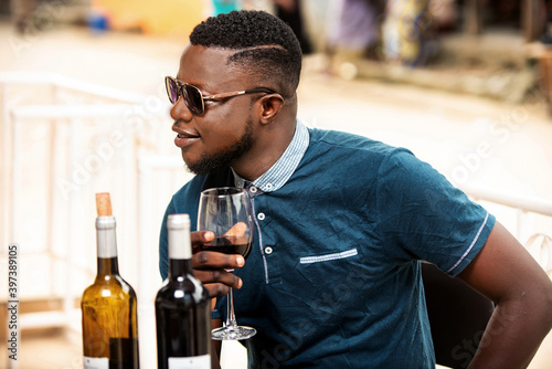 handsome young man drinking red wine
