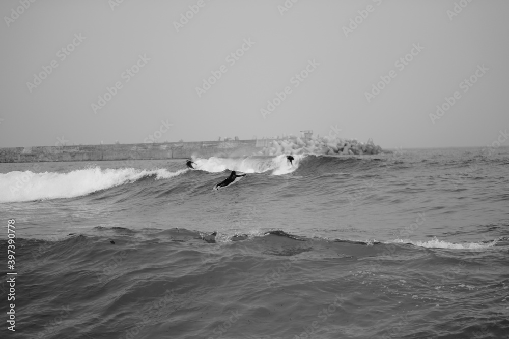 surfers riding a wave