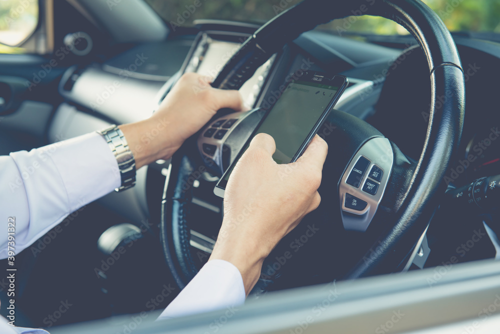  Closeup of hand using smart phone, business man busy driving,uses the navigation in the smartphone