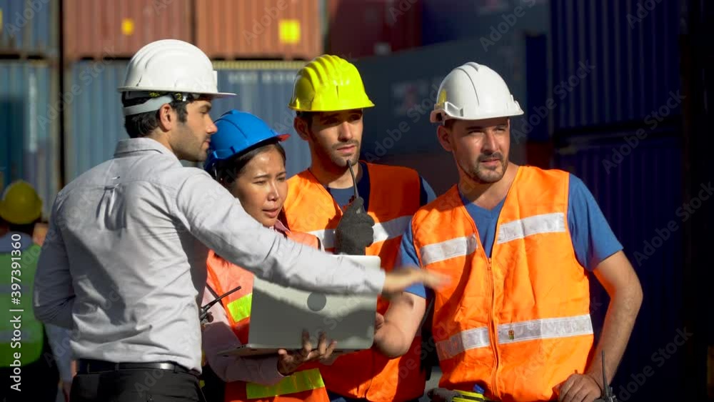 Foreman and secretary using laptop computer meeting with worker to checking control loading Containers box at warehouse logistic in Cargo freight ship for import export in harbor. shipping in docks. Foreman and secretary using laptop computer meeting with worker to checking control loading Containers box at warehouse logistic in Cargo freight ship for import export in harbor. shipping in docks.