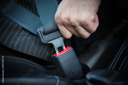 Hand fastening seat belt in the car