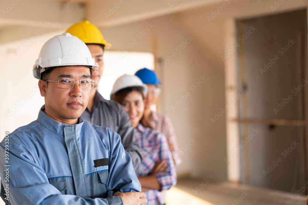 Portrait of asian engineers were crossed arms for planning in construction site, engineering team concept Portrait of asian engineers were crossed arms for planning in construction site, engineering team concept