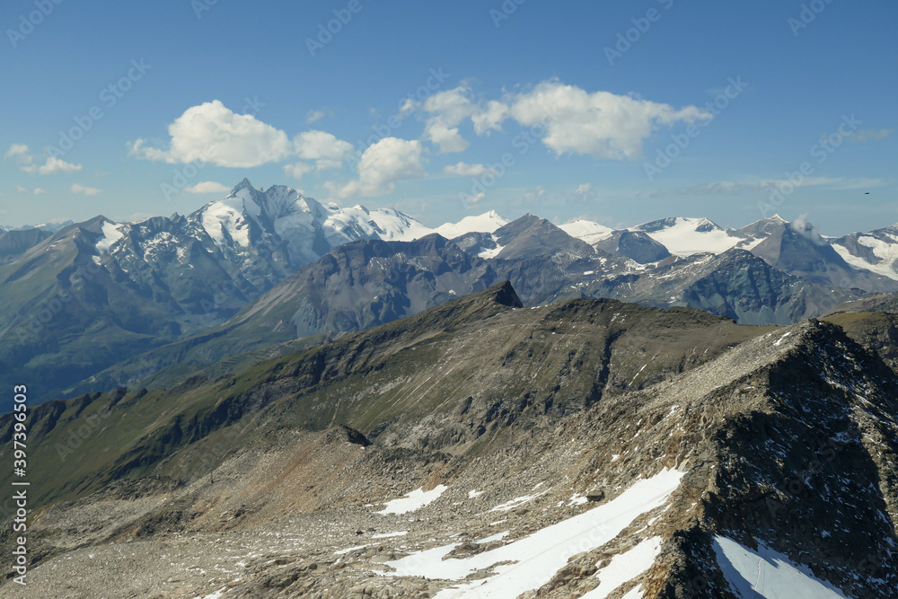 Panoramic view from top of Hohe Sonnblick in Austrian Alps on Gro?glockner. The whole area is very steep and dangerous, with many lose stones. Many mountain chains in the back. Sunny day. Expedition