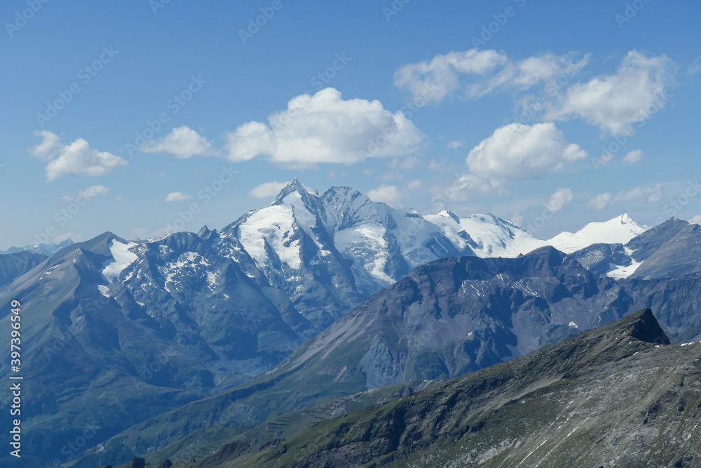Panoramic view from top of Hohe Sonnblick in Austrian Alps on Gro?glockner. The whole area is very steep and dangerous, with many lose stones. Many mountain chains in the back. Sunny day. Expedition